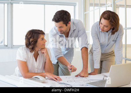 Business people working on blueprints at office Stock Photo