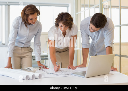 Business people working on blueprints at office Stock Photo