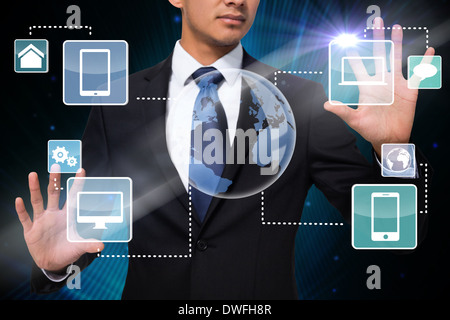 Businessman touching earth interface with graphics Stock Photo