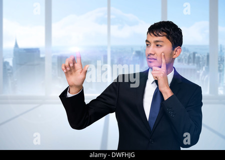 Serious businessman touching light Stock Photo