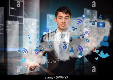 Serious businessman touching apps in cloud Stock Photo