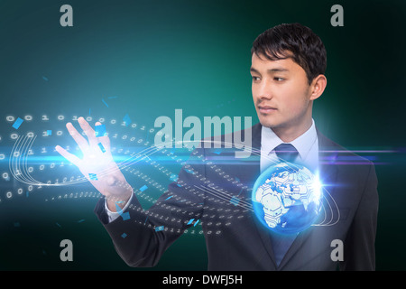 Asian businessman touching binary code with earth Stock Photo