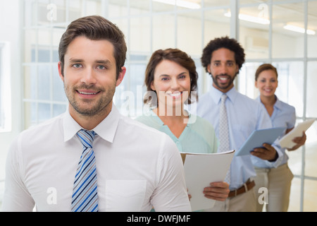 Business colleagues holding notepads in row Stock Photo