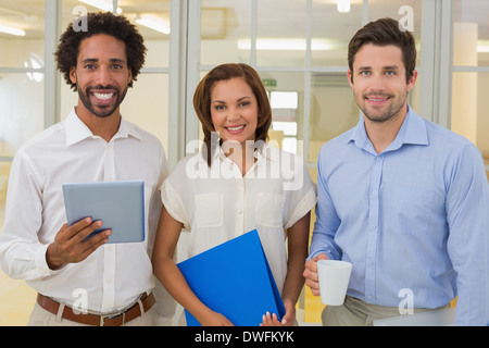 Business colleagues holding folder coffee cup and digital tablet in office Stock Photo