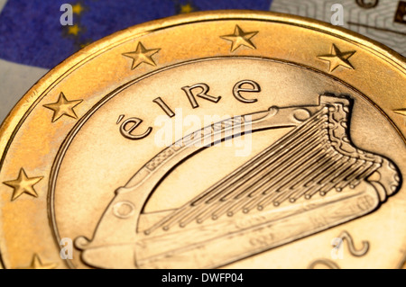 Irish 1 Euro coin on €5 note Stock Photo