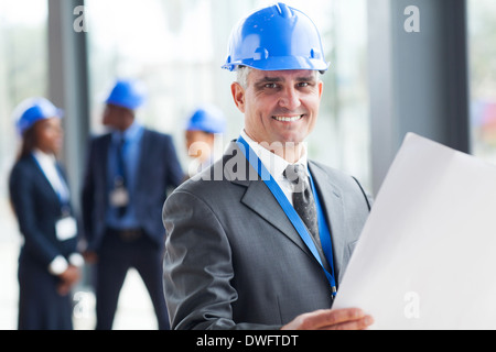 senior construction engineer holding blue print Stock Photo