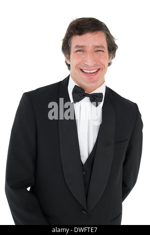 Portrait of groom in tuxedo smiling Stock Photo