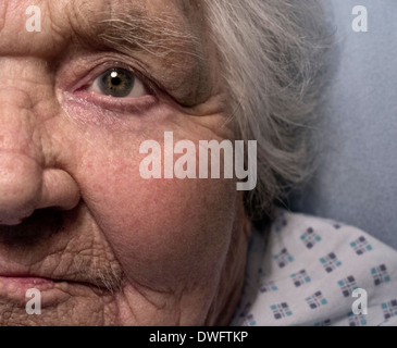 elderly lady face vulnerable 100 years old lady alone in hospital care bed senior health dementia care bed long term Stock Photo