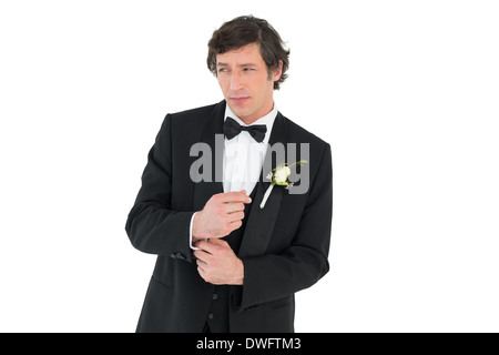 Groom in tuxedo adjusting cuff link Stock Photo
