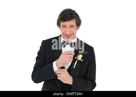 Smiling groom in tuxedo getting ready Stock Photo