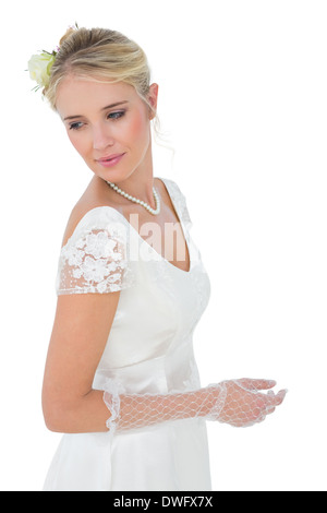 Bride looking over shoulder against white background Stock Photo