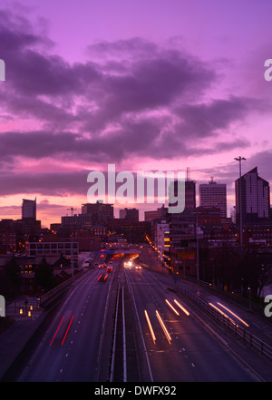 traffic trails of traffic heading too and from the city of leeds at sunset leeds yorkshire uk Stock Photo