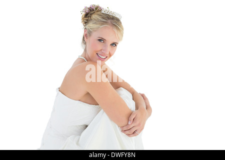 Young bride hugging knees over white background Stock Photo