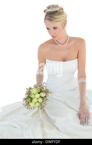 Bride sitting down with bouquet on her dress in black and white Stock ...
