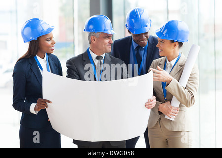 team of successful architects interacting in office Stock Photo