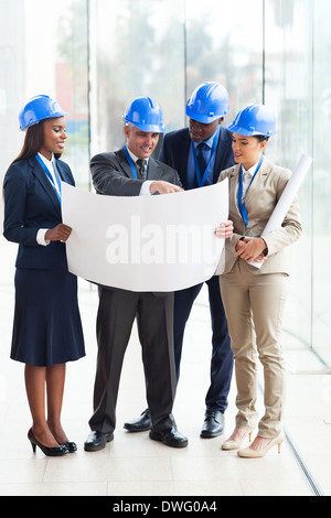 group of four architects working on a project at the office Stock Photo