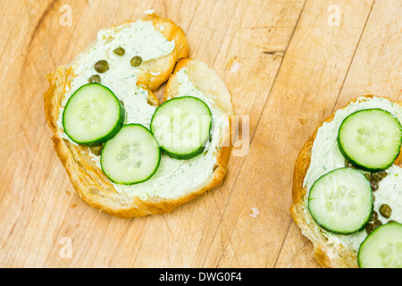 Preparing lox delight sandwich with fresh croissant. Stock Photo