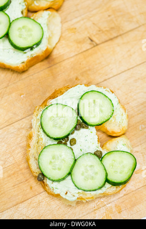 Preparing lox delight sandwich with fresh croissant. Stock Photo