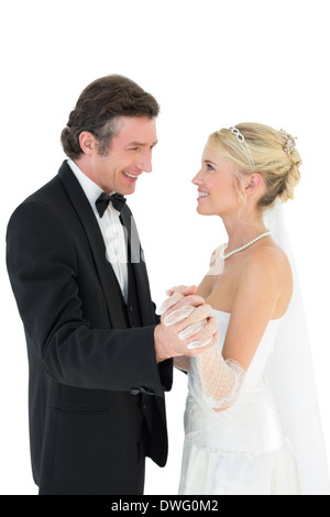 Newly wed couple holding hands while dancing Stock Photo