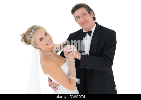 Happy couple dancing over white background Stock Photo