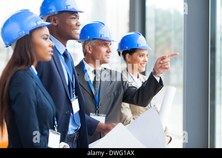 group of successful architects discussing project in modern office Stock Photo