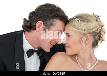 Smiling bride and groom with head to head Stock Photo