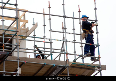 A construction worker working  with pipes on a new building Stock Photo