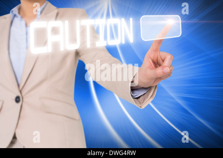 Businesswomans finger touching caution button Stock Photo