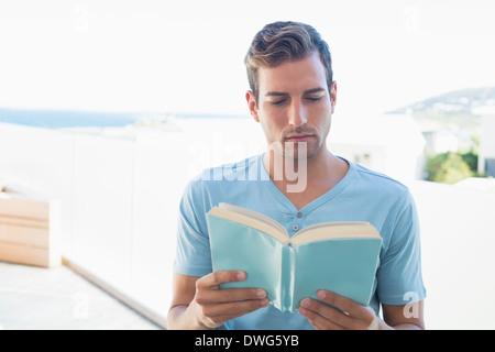 Concentrated man reading book Stock Photo