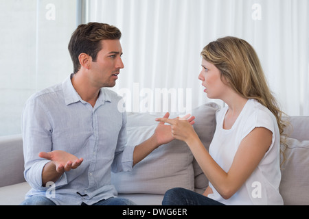 Couple having an argument in living room Stock Photo