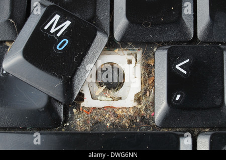 Dirty computer keyboard with keys removed for cleaning Stock Photo