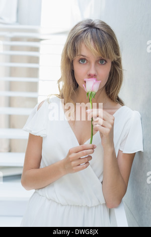 Portrait of a beautiful woman smelling flower Stock Photo