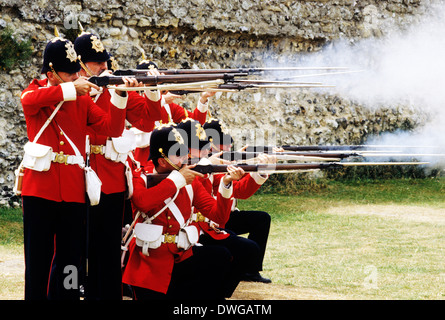 57th Middlesex Regiment, 1880, riflemen firing volley, historical re-enactment 19th century British Army soldier soldiers uniform uniforms England UK rifle rifles redcoats Stock Photo