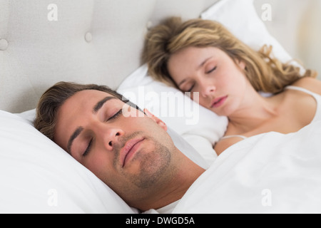 Couple sleeping together in bed Stock Photo