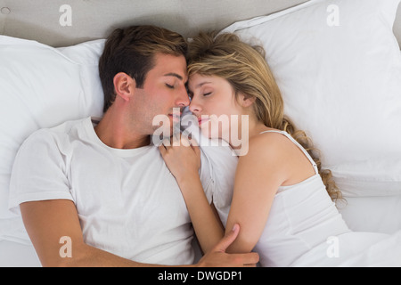 Couple sleeping together in bed Stock Photo