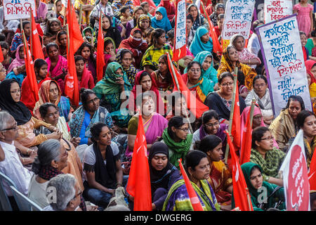 Dhaka, Bangladesh. 7th Mar, 2014. Women take part in the Bangladeshi Communist Party rally for International Women's Day, holding flags and signs bearing the globally recognized communism symbols of the hammer and sickle. The Communist Party of Bangladesh organized an International Women's Day rally ahead of the date itself, demanding resistance against all kind of repression, discrimination and violence against women. Credit:  Zakir Hossain Chowdhury/NurPhoto/ZUMAPRESS.com/Alamy Live News Stock Photo