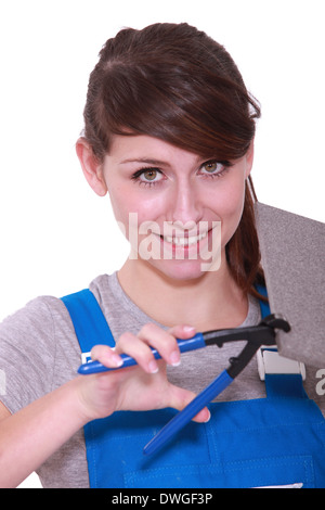 handywoman using pliers on a tile Stock Photo