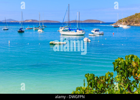 Sailboats and power boats anchored in crystal clear turquoise waters in the Caribbean Stock Photo