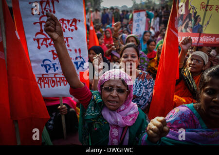 Dhaka, Bangladesh. 7th Mar, 2014. Women take part in the Bangladeshi Communist Party rally for International Women's Day, holding flags and signs bearing the globally recognized communism symbols of the hammer and sickle. The Communist Party of Bangladesh organized an International Women's Day rally ahead of the date itself, demanding resistance against all kind of repression, discrimination and violence against women. Credit:  Zakir Hossain Chowdhury/NurPhoto/ZUMAPRESS.com/Alamy Live News Stock Photo