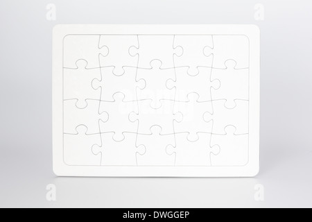 Assembled jigsaw puzzle with 20 blank pieces. Standing upright. Isolated on white. Stock Photo