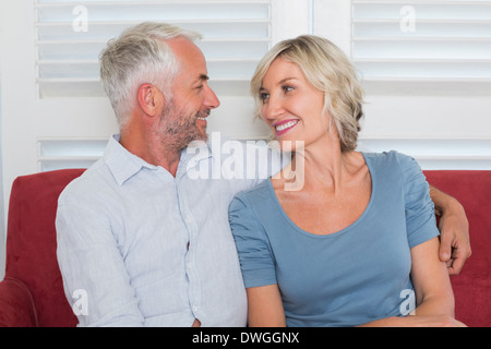 Relaxed mature couple sitting on couch Stock Photo