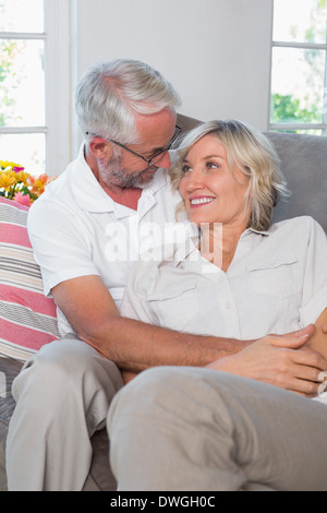 Relaxed mature couple sitting on sofa Stock Photo