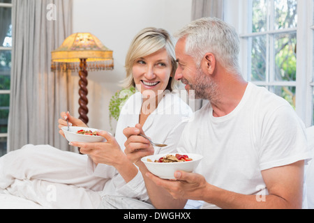Mature couple having breakfast in bed Stock Photo