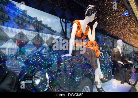 Mannequin posing on car in Christmas window decorations at Au Printemps department store, Paris, France Stock Photo