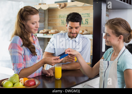 Couple paying bill at coffee shop using card bill Stock Photo
