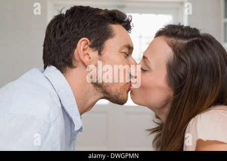 Close-up side view of a loving couple kissing Stock Photo