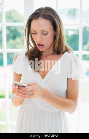 Shocked woman reading text message Stock Photo