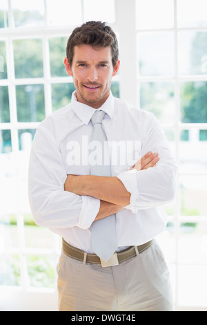 Smart businessman with hands folded at home Stock Photo
