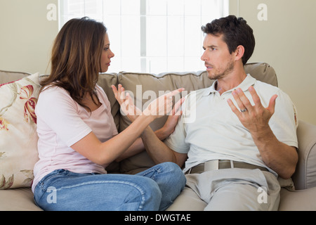 Couple having an argument in living room Stock Photo