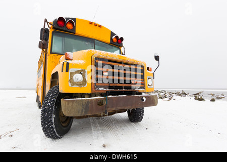 School bus parked by Bowhead Whale bones for Polar Bear viewing at Kaktovik, Alaska in October. Stock Photo